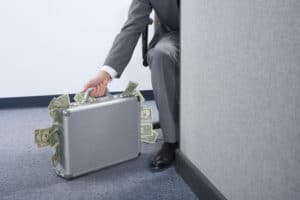 Businessman with a briefcase of money